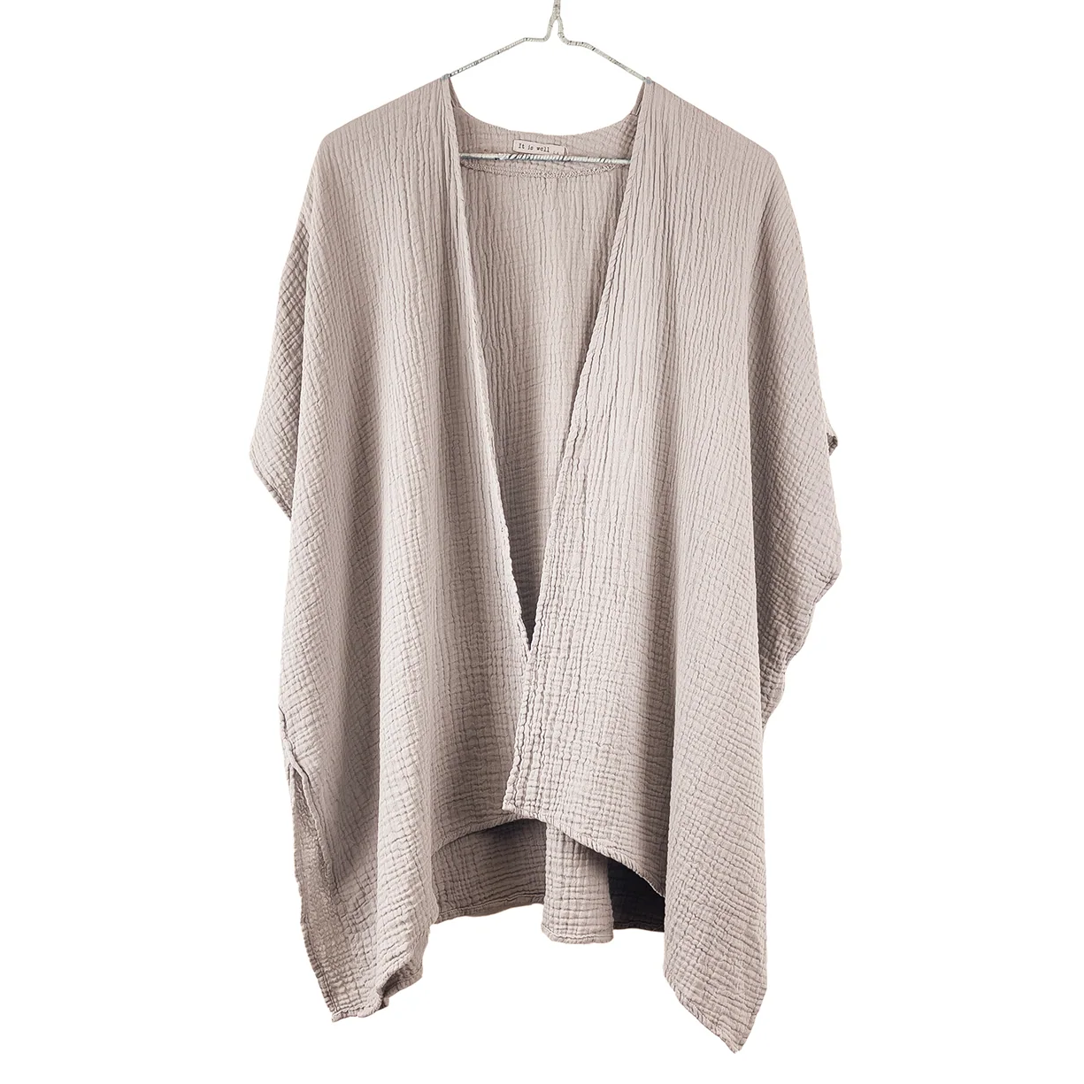 Beige cardigan on a hanger against a white background