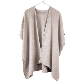 Beige cardigan on a hanger against a white background