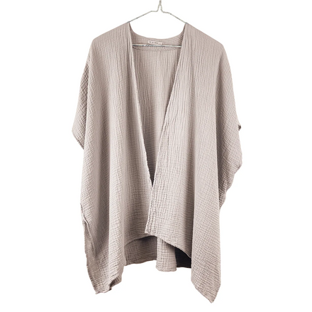 Beige cardigan on a hanger against a white background
