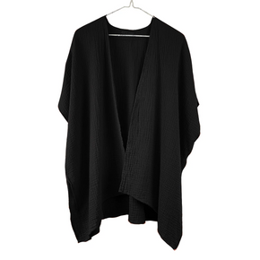 Black cardigan on a white hanger against a white background