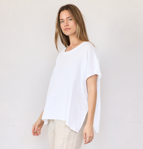 Woman wearing a white blouse against a plain background