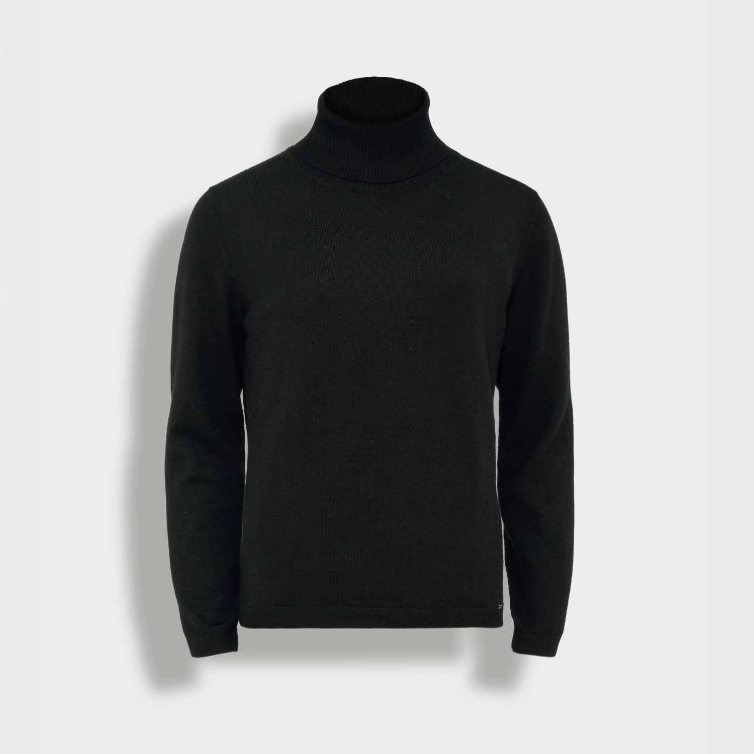 Black turtleneck sweater on a light gray background