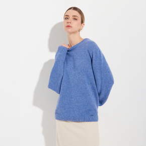 Woman wearing a blue sweater against a white background