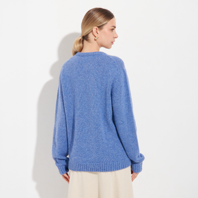 Woman wearing a blue sweater on a white background