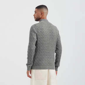 Man wearing a gray textured sweater on a white background
