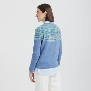 Woman wearing a blue striped sweater on a white background