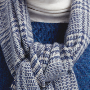 Close-up of a blue and white checkered scarf with a blurred background