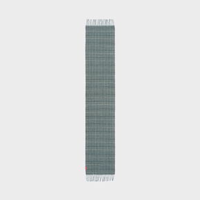 Green plaid scarf on a neutral background.