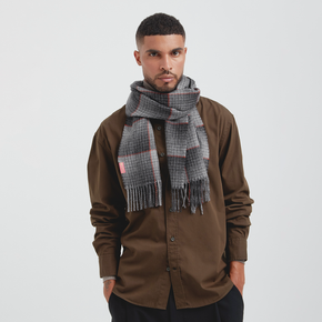 Man wearing a brown shirt and plaid scarf on a white background
