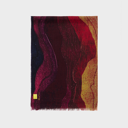 Colorful abstract patterned shawl on a white background