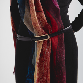 Colorful scarf with a black belt on a neutral background