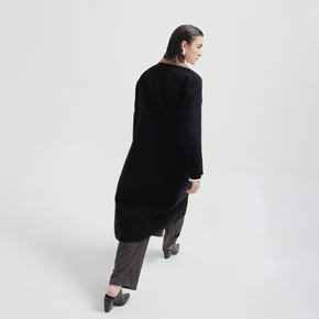 Person wearing a black coat on a white background