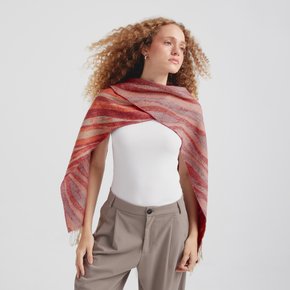 Woman wearing a red and orange striped scarf on a white background