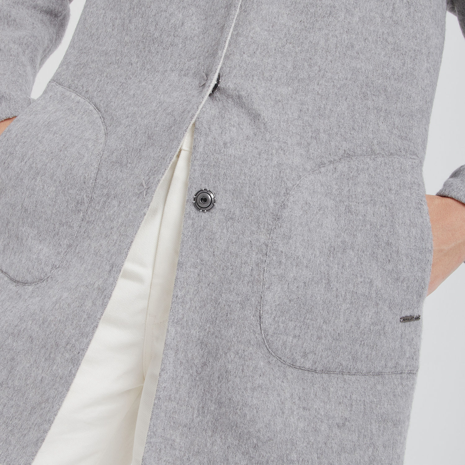 Gray jacket with a snap detail on a white background
