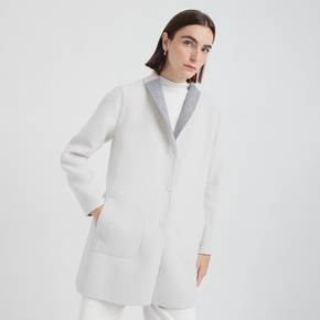 Woman wearing a white coat with a white background
