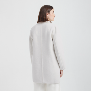 Person wearing a white coat on a white background