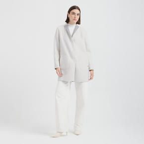 Person wearing a white coat and pants on a white background