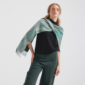 Woman wearing a green and blue striped scarf on a white background