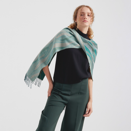 Woman wearing a green and blue striped scarf on a white background