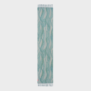 Teal and beige patterned scarf on a light gray background