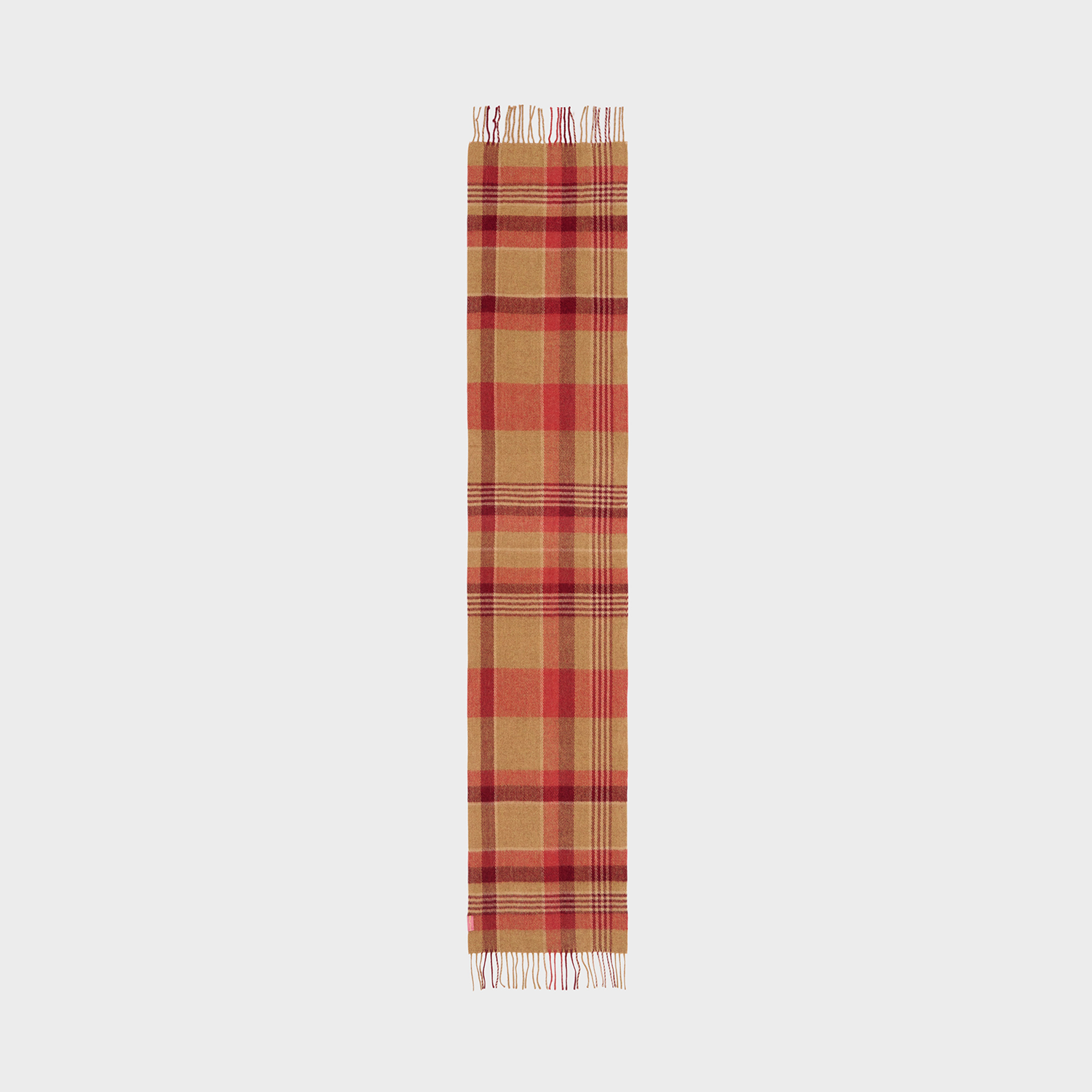 Plaid scarf with fringe on a neutral background.