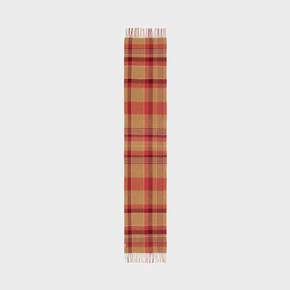 Plaid scarf with fringe on a neutral background.