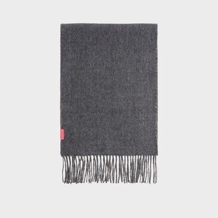 Gray scarf with fringes on a light gray background