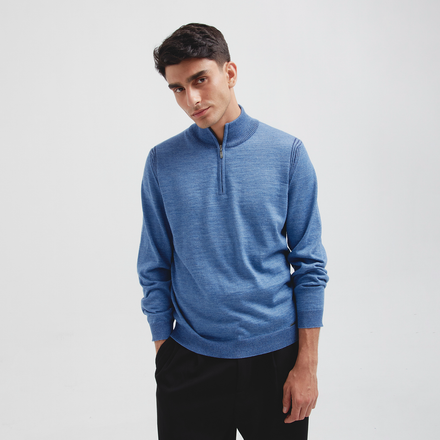 Man wearing a blue sweater with a zipper on a white background