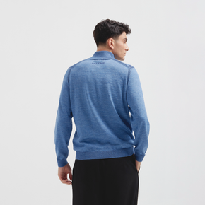 Man wearing a blue sweater on a light gray background