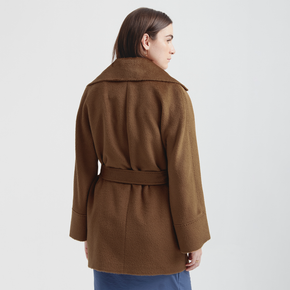 Person wearing a brown coat on a white background