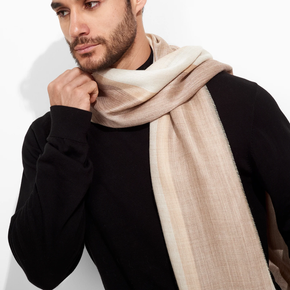 Man wearing a beige scarf against a white background