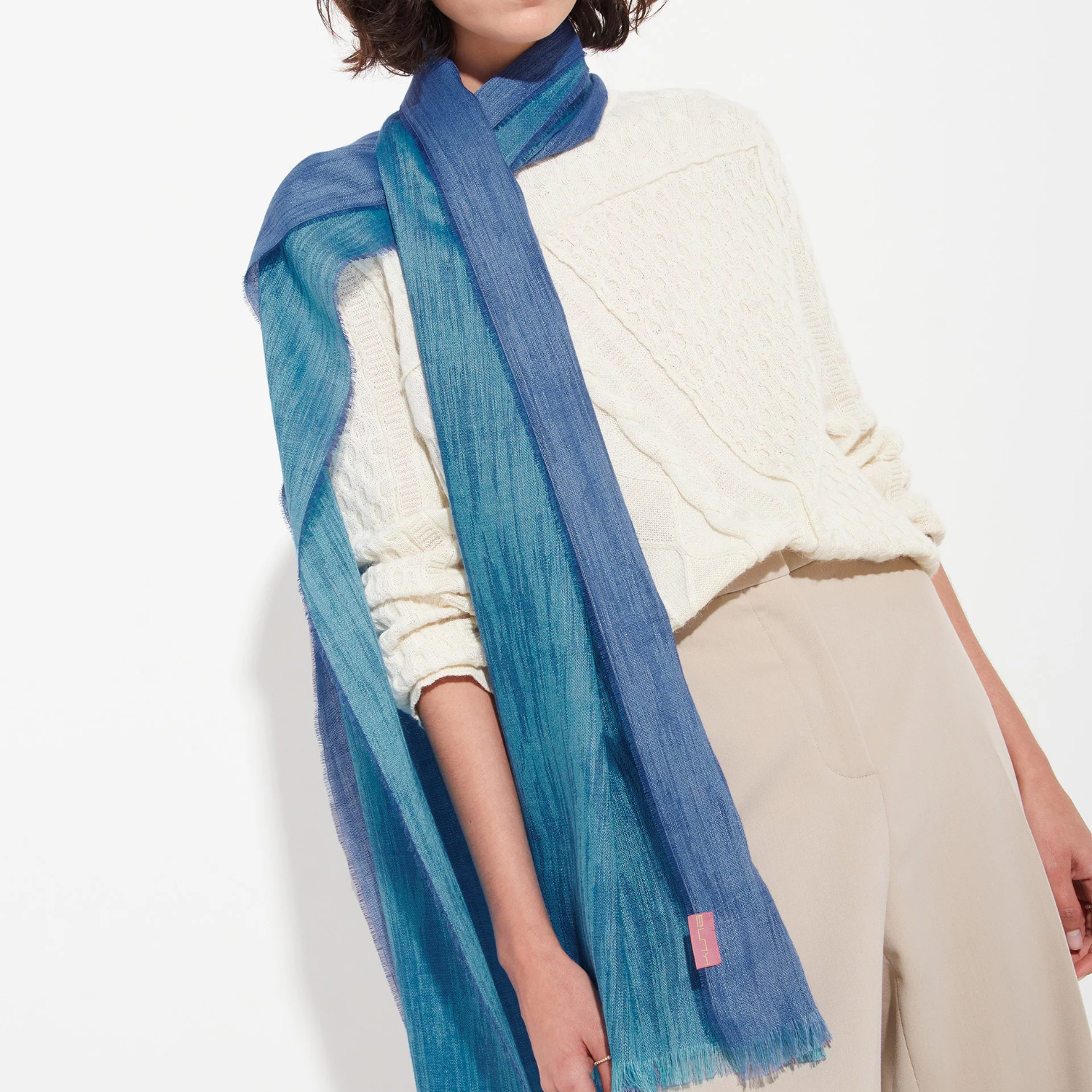 Person wearing a blue scarf with a white background
