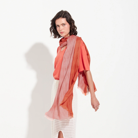 Woman wearing a colorful scarf on a white background