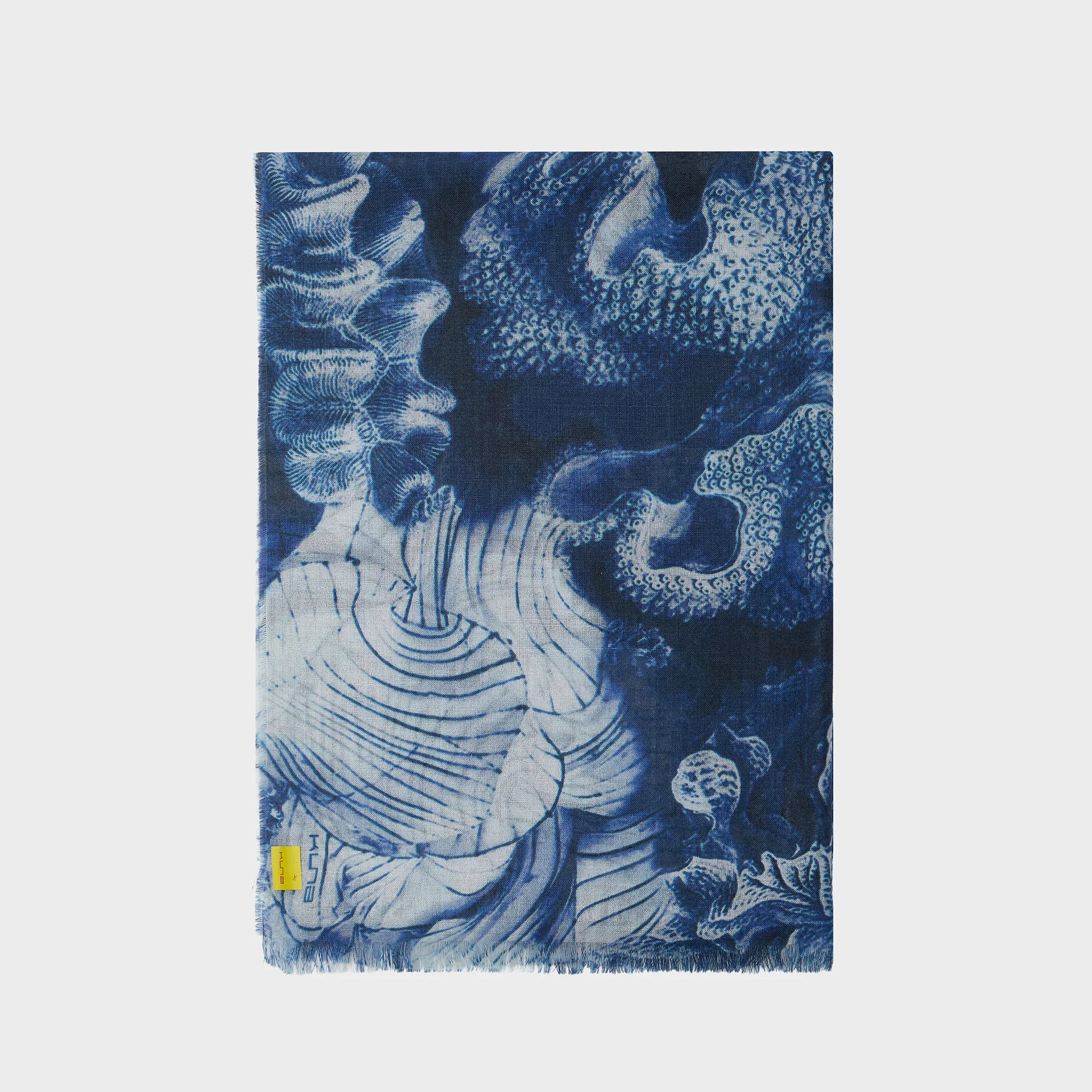 Blue and white patterned shawl with an abstract design on a light gray background