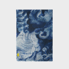 Blue and white patterned shawl with an abstract design on a light gray background