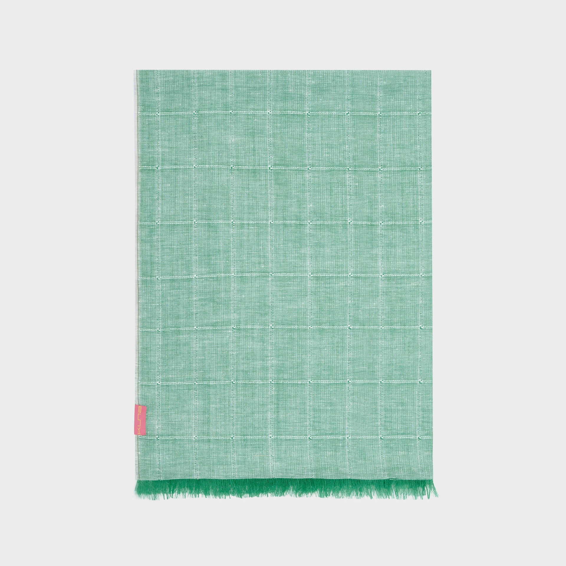 Green woven shawl with a pink tag on a white background