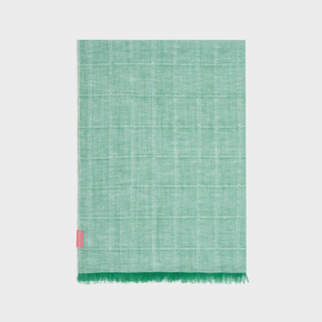 Green woven shawl with a pink tag on a white background