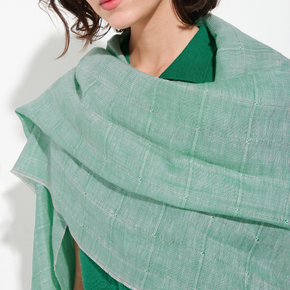 Green shawl draped over a person on a white background