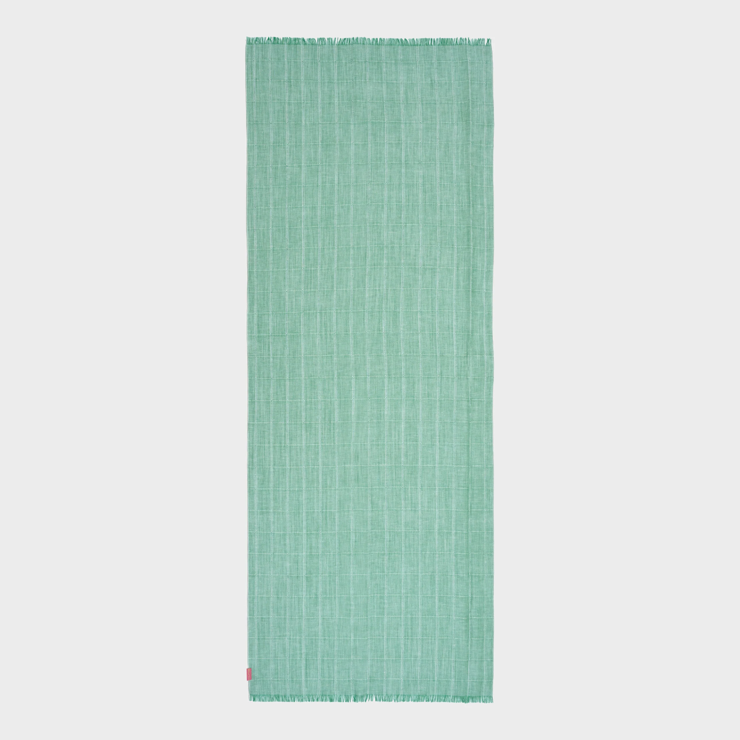 Green woven shawl on a light gray background