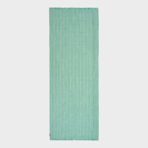 Green woven shawl on a light gray background