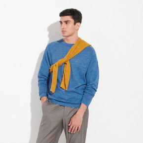 Man wearing a blue sweater with a yellow scarf on a white background