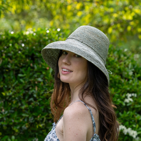 Woman wearing a wide-brimmed hat in a garden setting