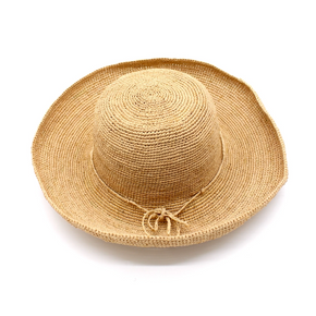Beige straw hat with a wide brim on a white background