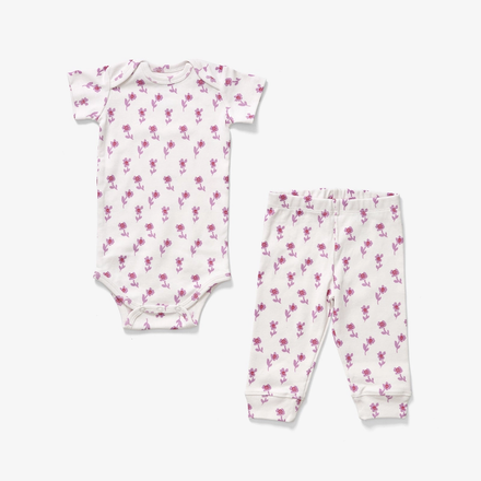 Baby romper and pants set with pink floral pattern on a white background