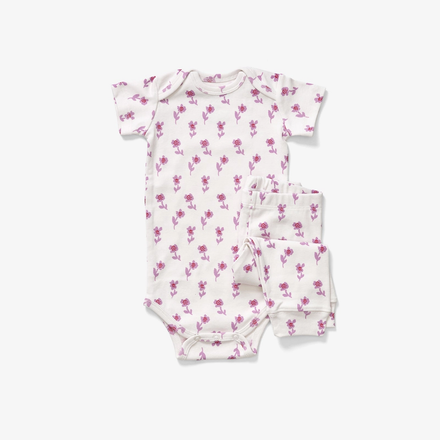Baby romper and pants with pink floral pattern on a white background