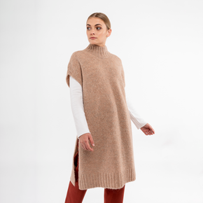 Front view of beige alpaca poncho with turtleneck, displaying soft alpaca material.