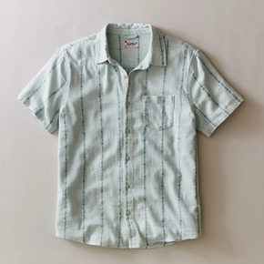 Short-sleeve button-up shirt with subtle pattern on a beige background