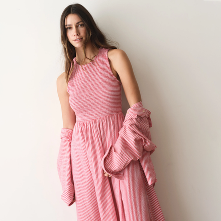 Woman wearing a pink dress against a white background