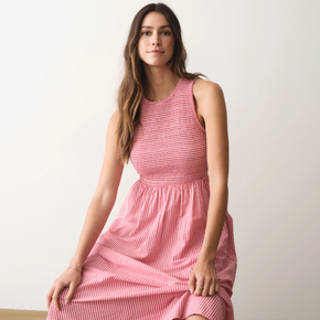 Woman wearing a pink dress against a plain background