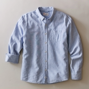 Light blue button-up shirt on a beige background